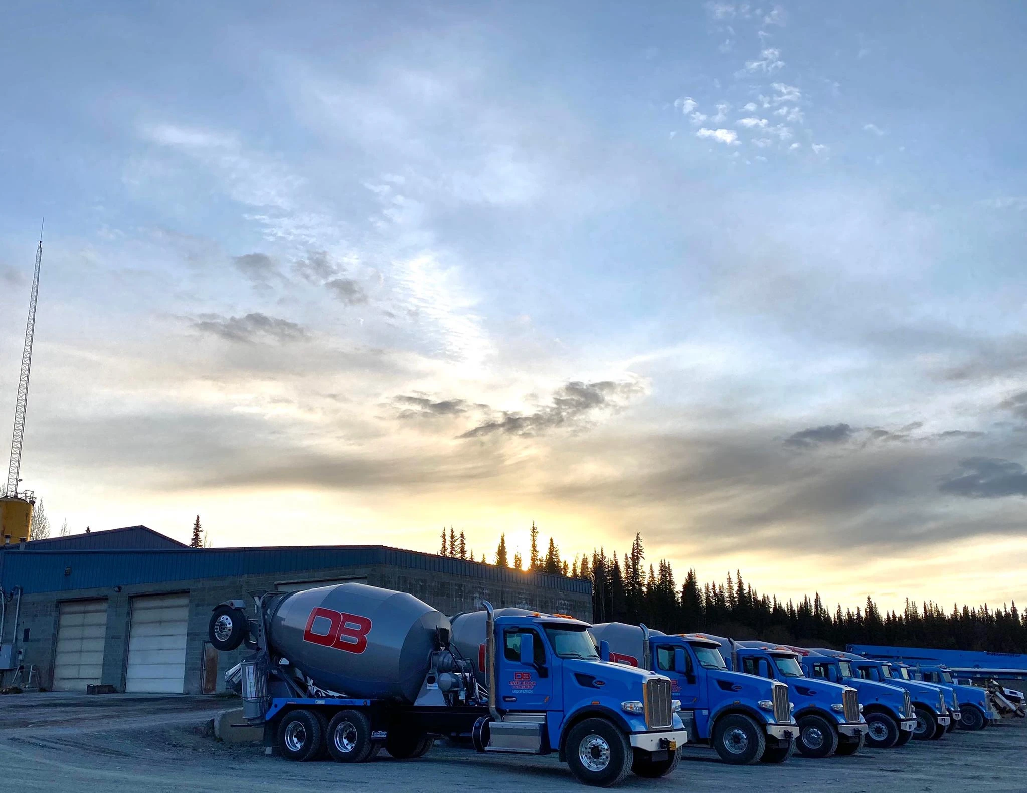 Davis Block mixer truck fleet at sunset — Kenai yard