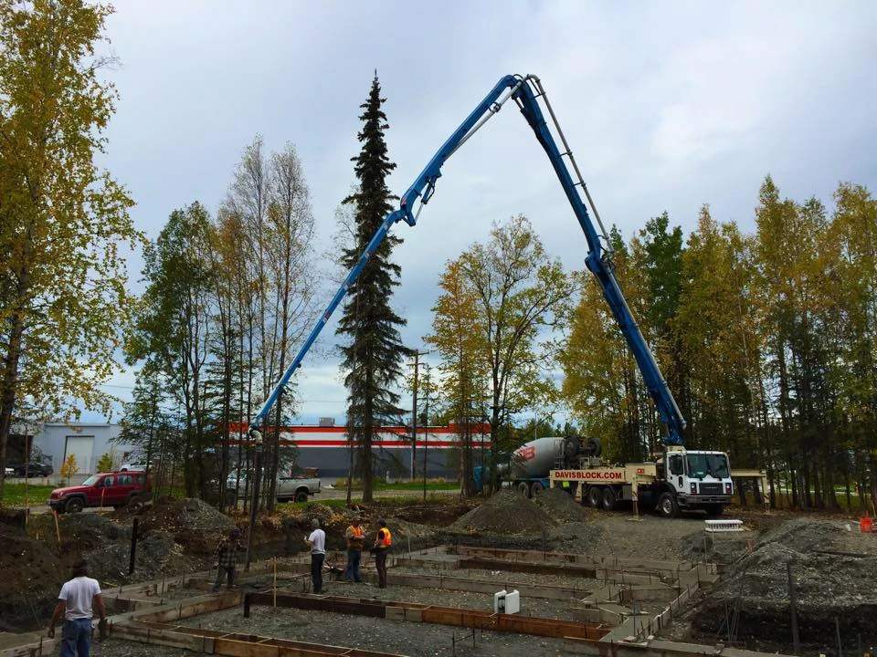 Davis Block pump truck at foundation pour — fall foliage