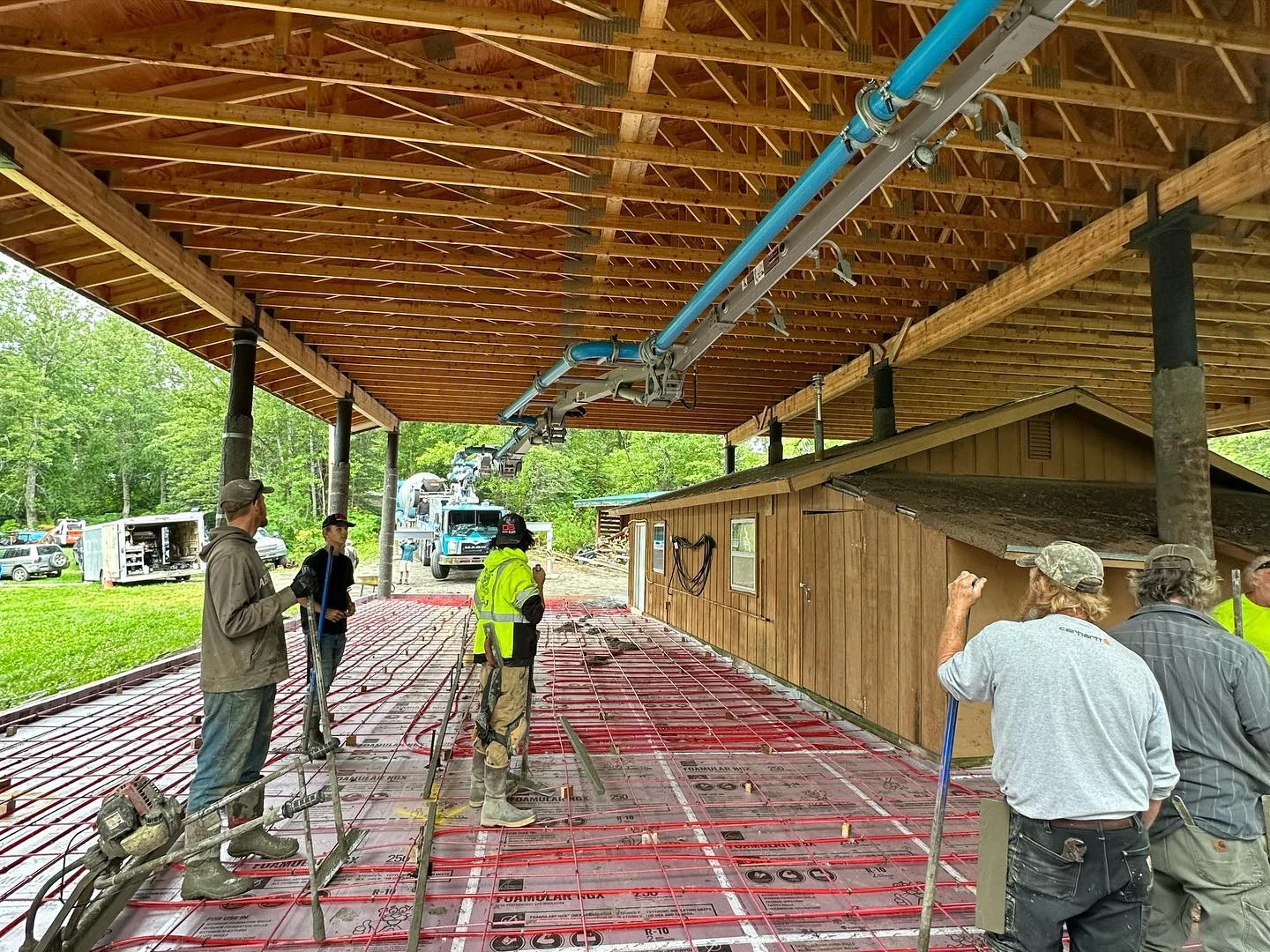 Davis Block pump truck pouring residential concrete slab — blue sky Alaska day